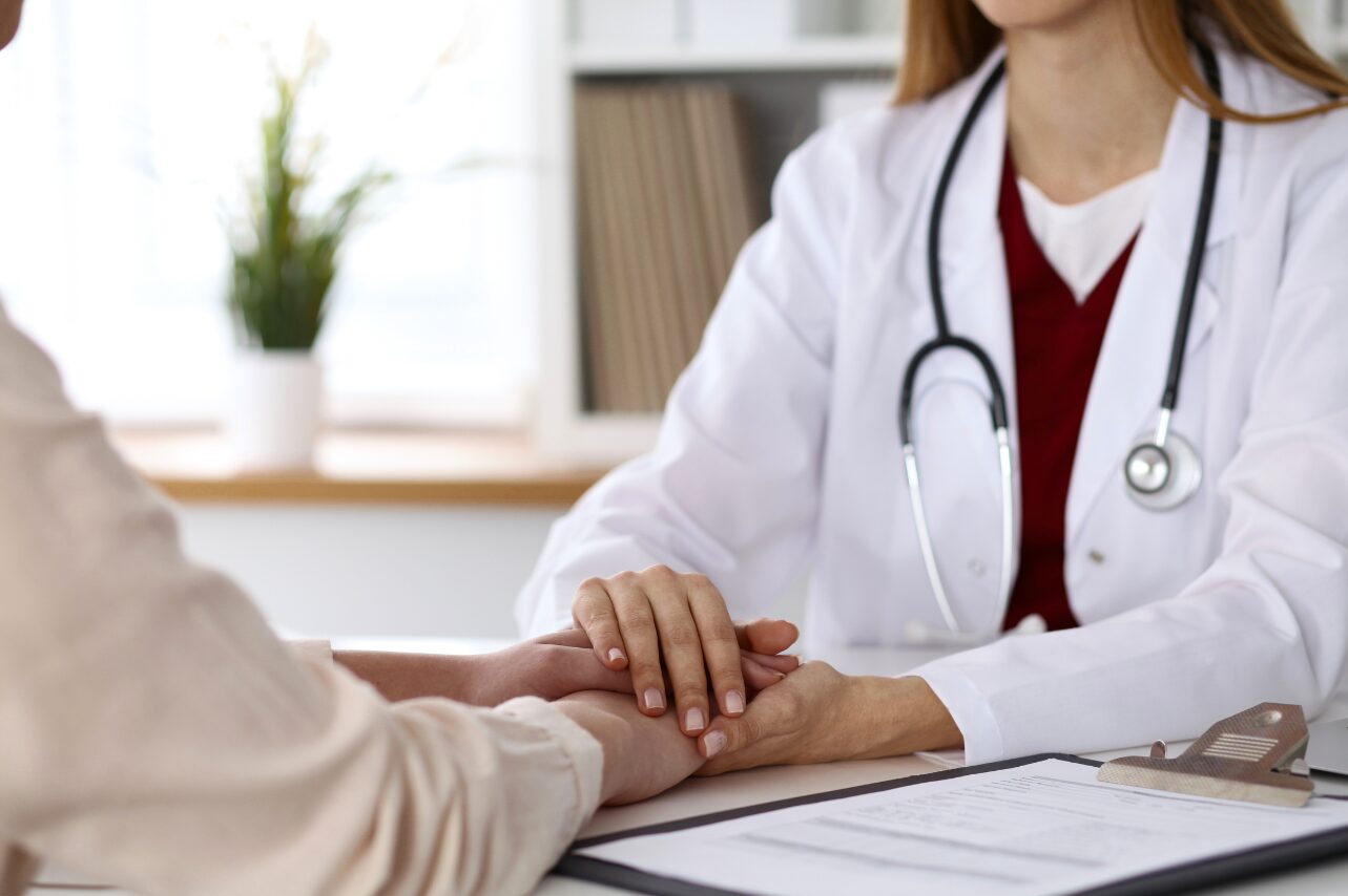 Doctor talking with a patient across a desk