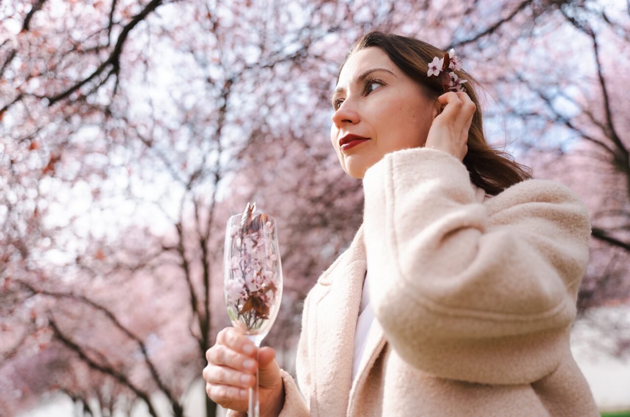 Woman among cherry blossom trees