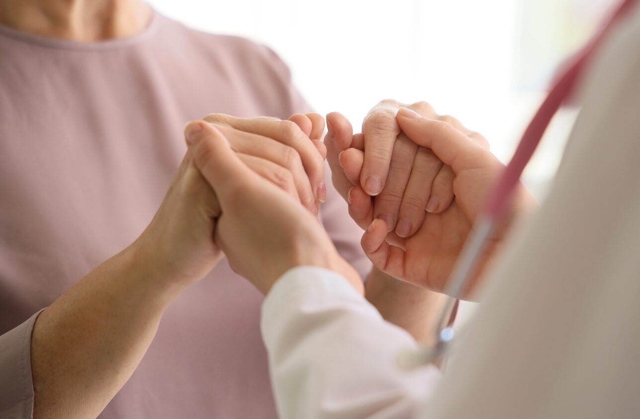 Clasped hands, offering support